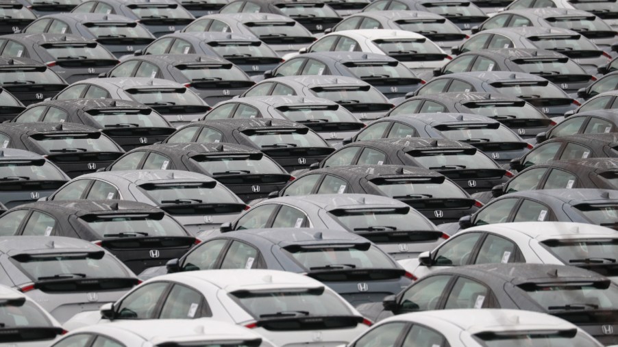 Many Honda Civic cars sit at a port waiting for purchase