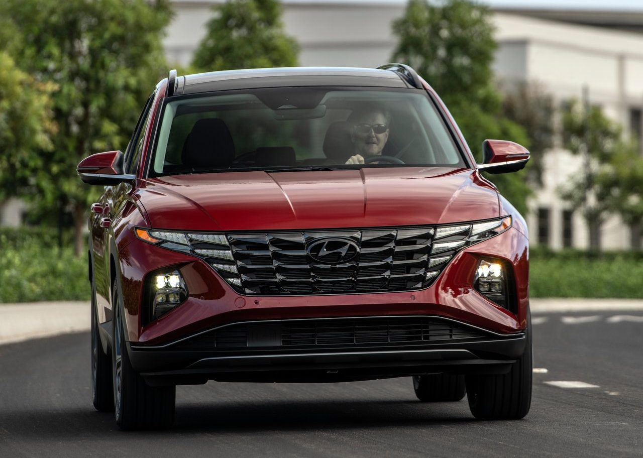 An image of a 2022 Hyundai Tucson driving outdoors.