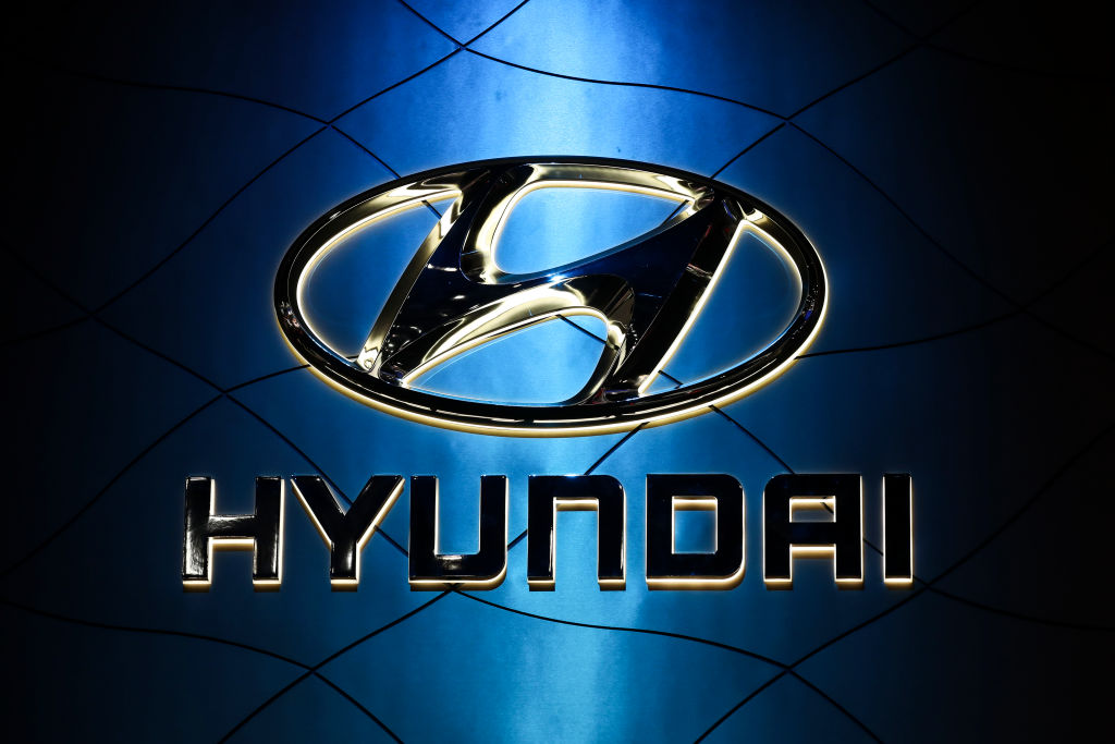 A photo of the Hyundai logo hanging in front of a light source