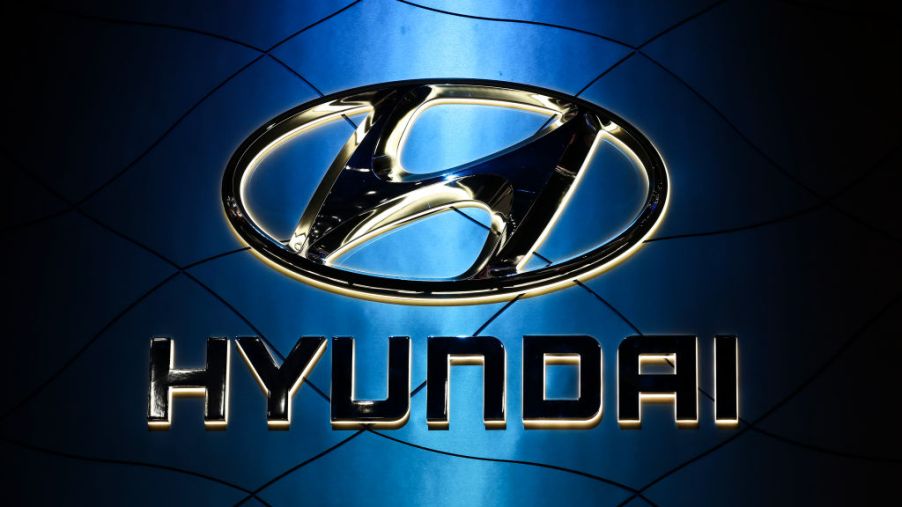 A photo of the Hyundai logo hanging in front of a light source