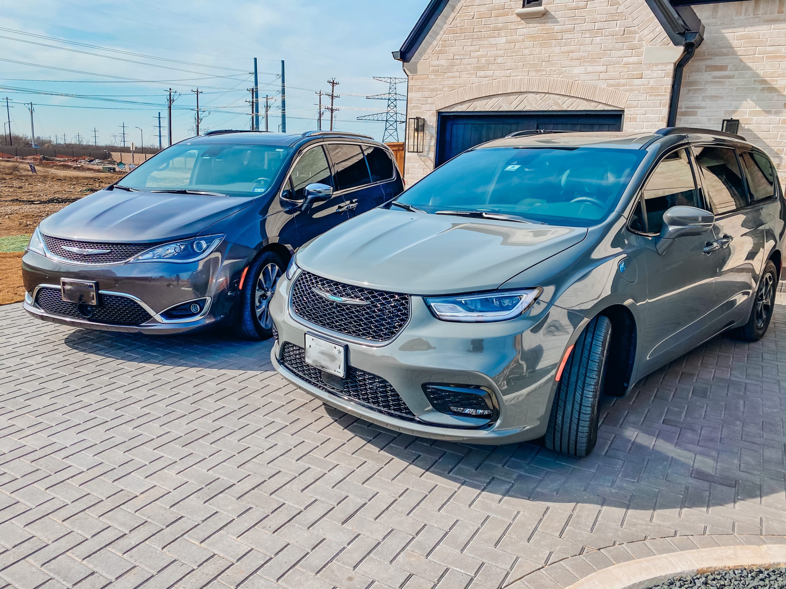 2020 and 2021 chrysler pacifica models in a driveway