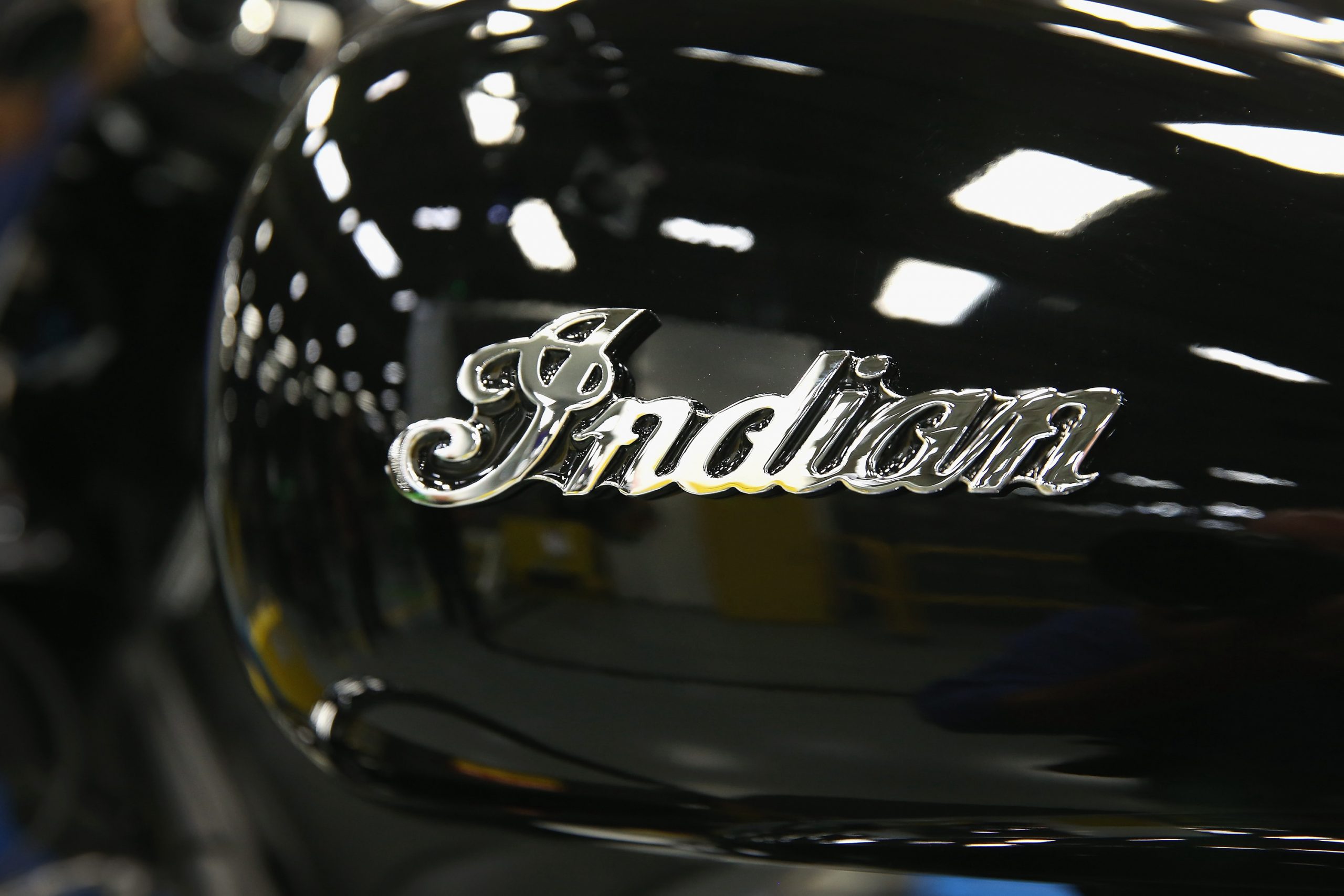 An Indian logo decorates the gas tank of an Indian Chief Vintage motorcycle sitting