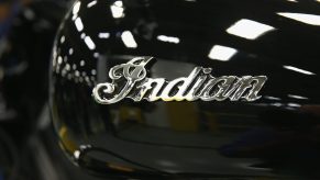 An Indian logo decorates the gas tank of an Indian Chief Vintage motorcycle sitting