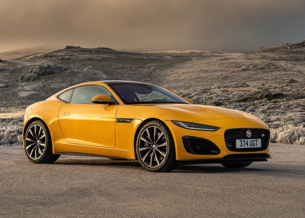 An image of a yellow Jaguar F-Type parked outside.
