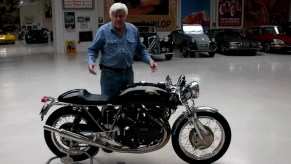 Jay Leno in his garage with his black Egli-Vincent by Godet