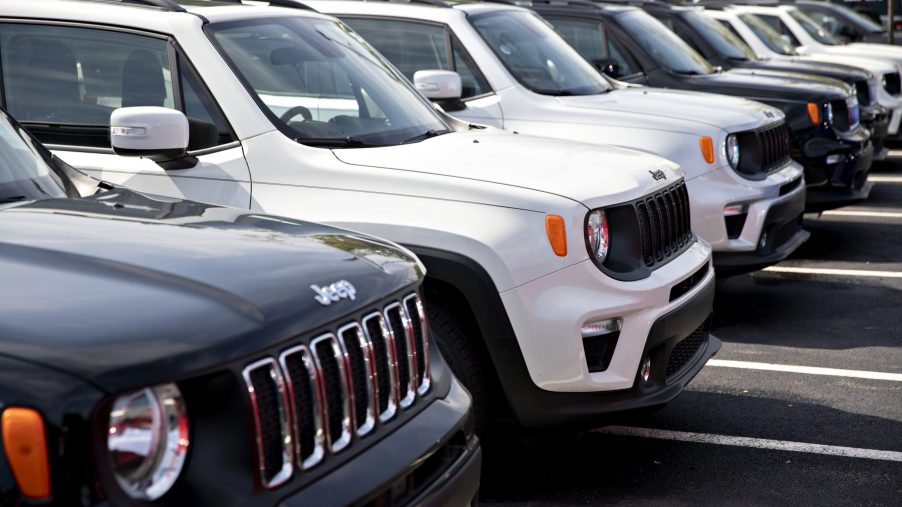 Jeep Renegade SUVs displayed on a dealership sales lot