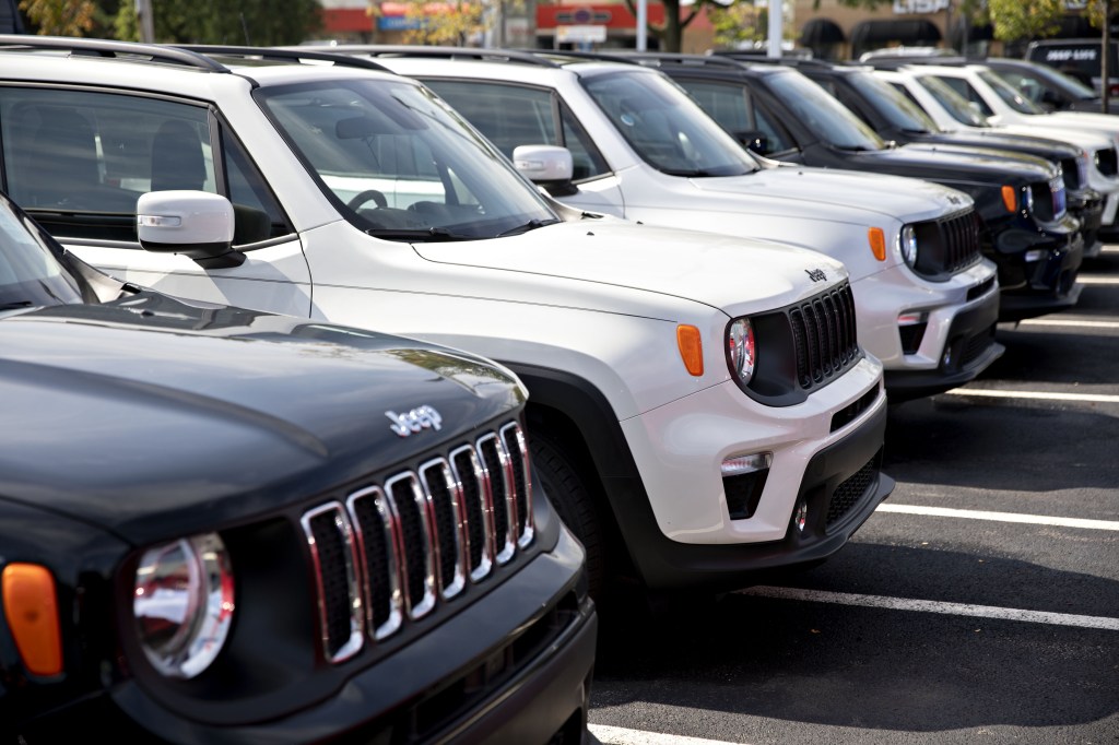 Jeep Renegade SUVs displayed on a dealership sales lot
