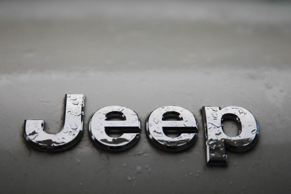  A rain-covered Jeep logo covered in rain drops