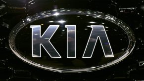 Chrome Kia Motors logo on a black vehicle