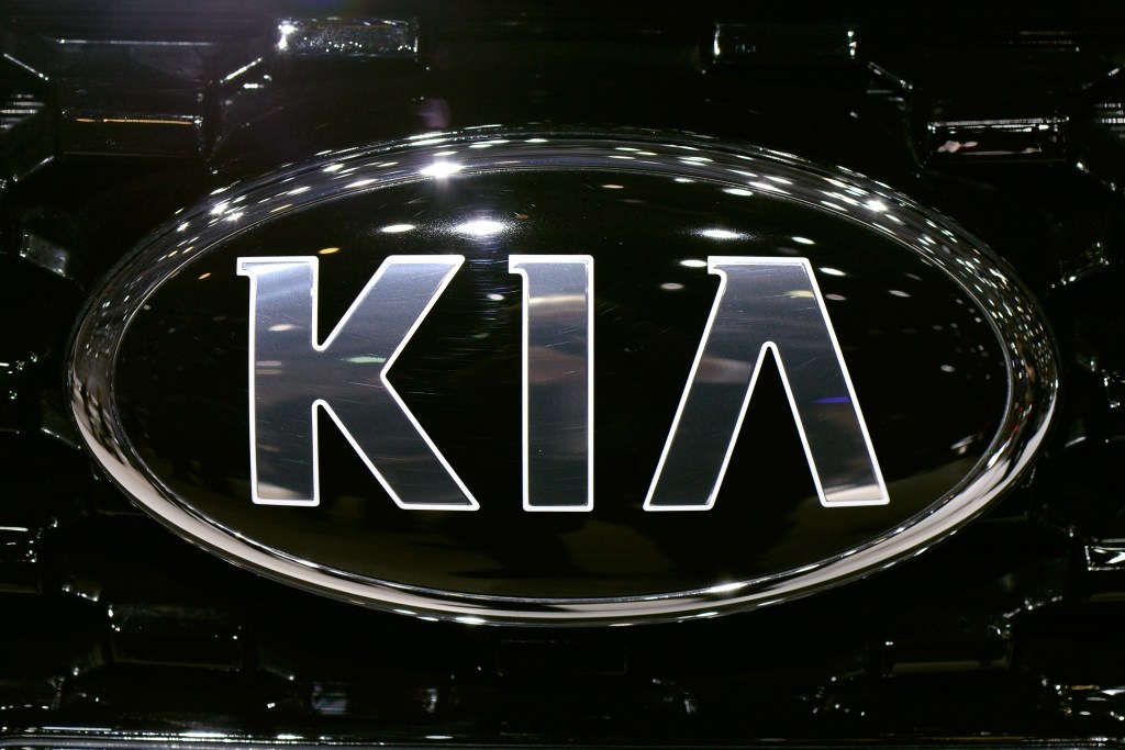 Chrome Kia Motors logo on a black vehicle