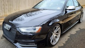 A black modified 2014 Audi S4 in a driveway