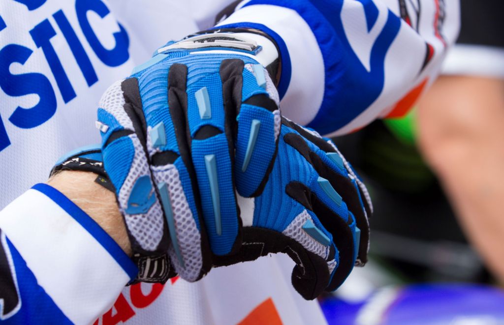 Motocross rider Calvin Vlaanderen puts on his blue riding gloves
