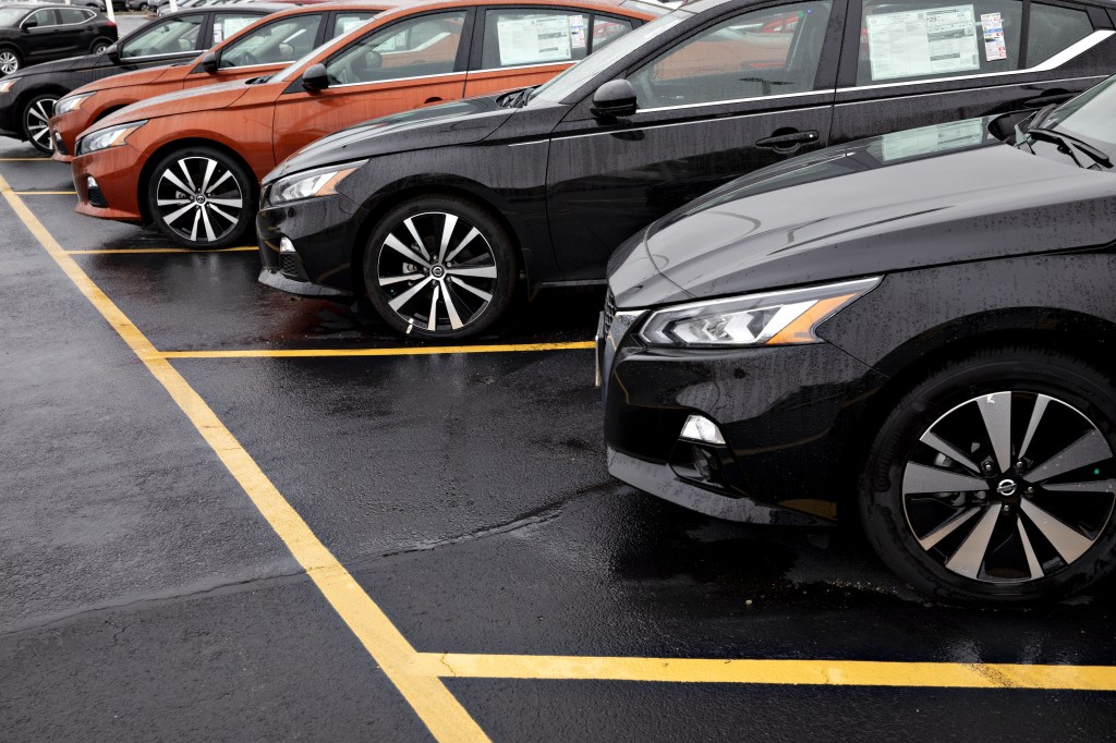 A row of Nissan Altima cars at a dealership