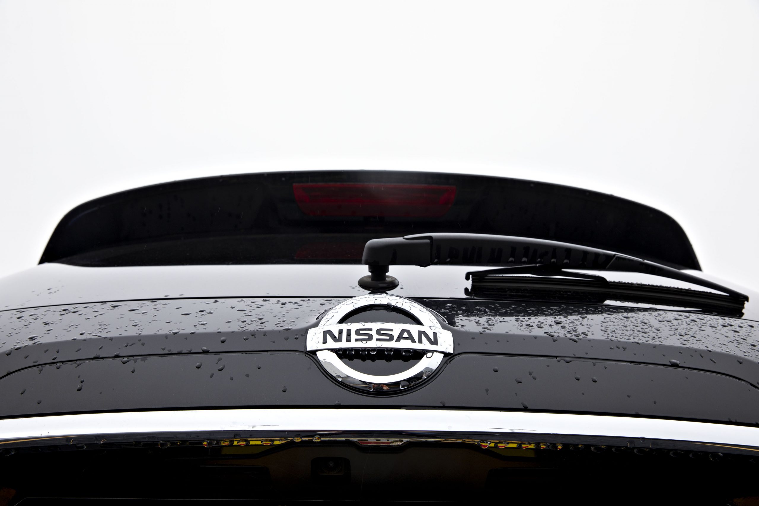 A Nissan logo seen on the back of a Rogue SUV