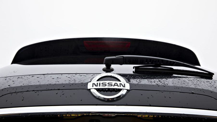 A Nissan logo seen on the back of a Rogue SUV