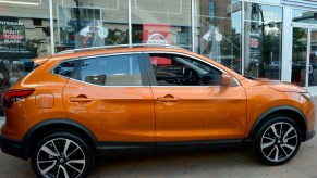 An orange Nissan Rogue on display