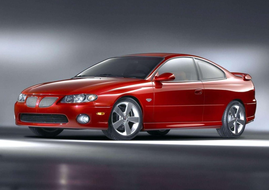 An image of a Pontiac GTO, one of many discontinued muscle cars, parked indoors.