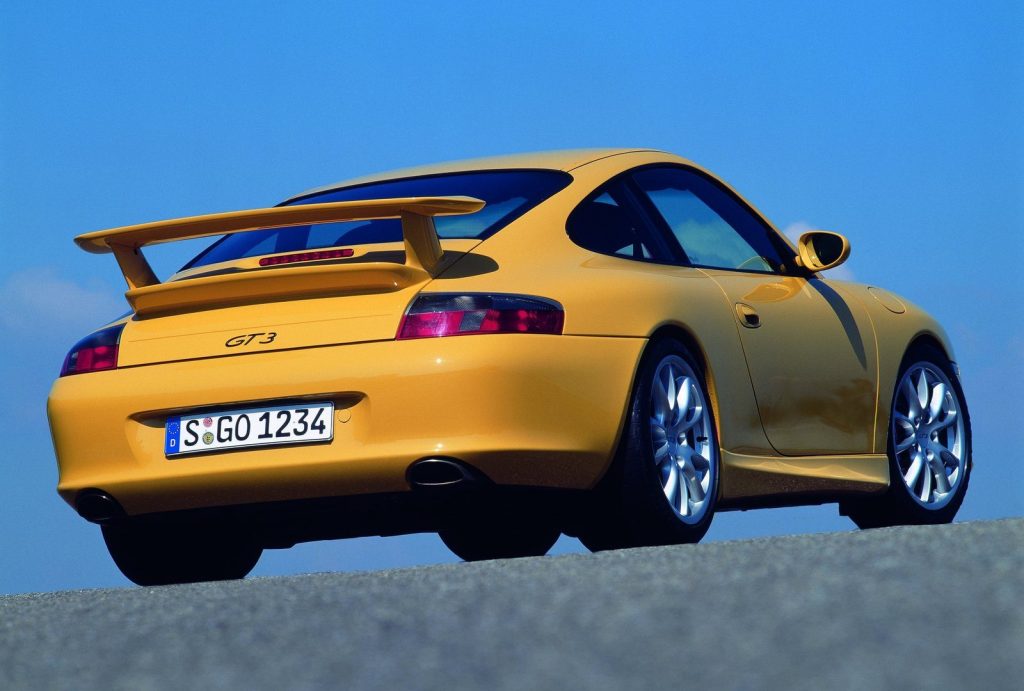 An image of a yellow Porsche 911 GT3 parked outside.