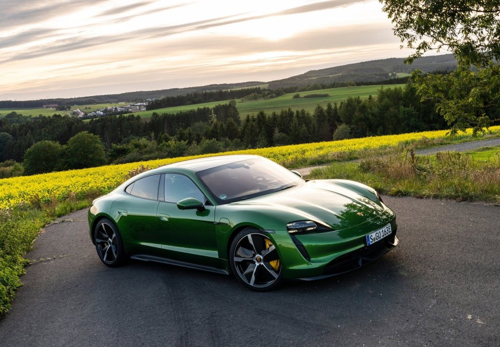 An image of a green Porsche Taycan Turbo S parked outside.