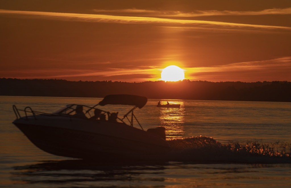 A boat on the water during sunset