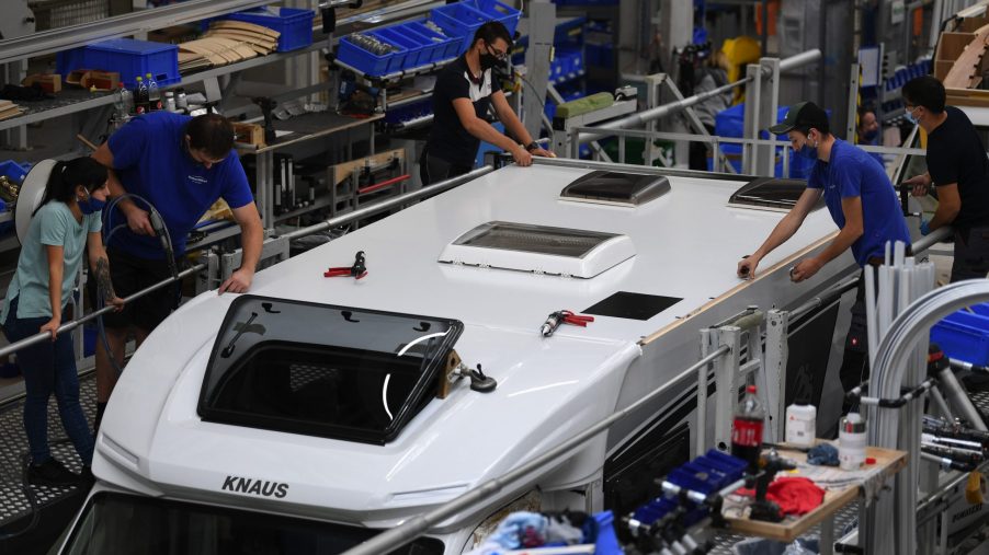 Employees fit the roof to a motorhome RV on the Knaus Tabbert AG assembly line