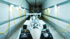 A white formula 1 race car made of cake and fondant sits in a cooled trailer