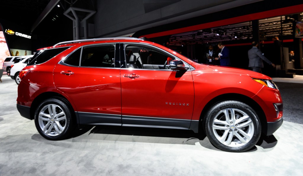 A red Chevy Equinox on display at an auto show
