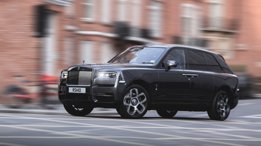 Rolls Royce Cullinan rolling down the street in the UK