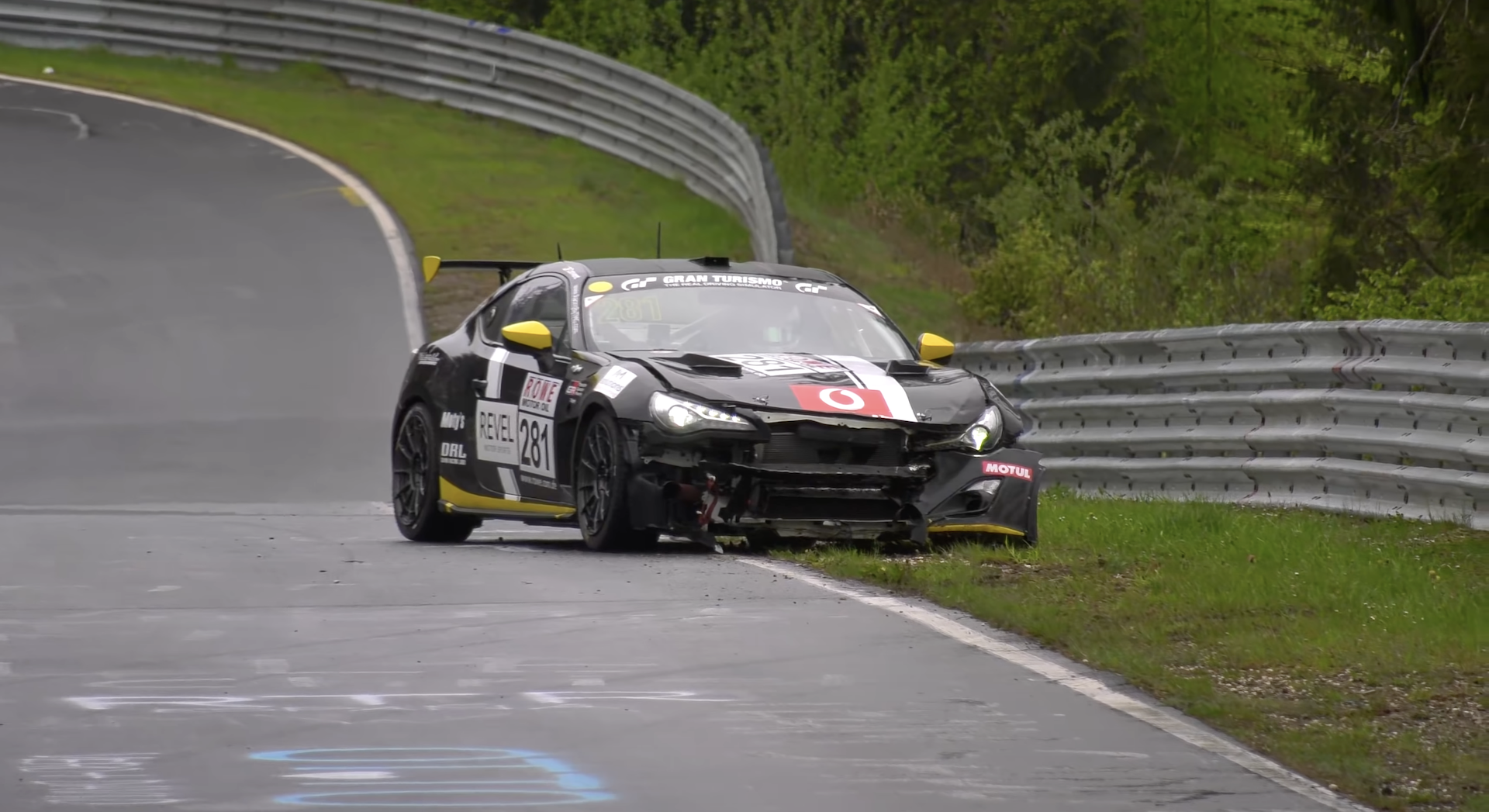 An image showing a crashed car on the Nürburgring track.