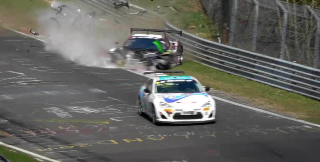An image showing a crashed car on the Nürburgring track.