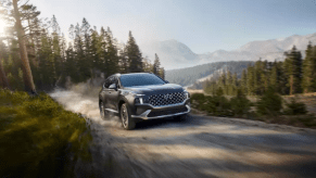 The 2021 Hyundai Santa Fe Hybrid driving on a dirt road