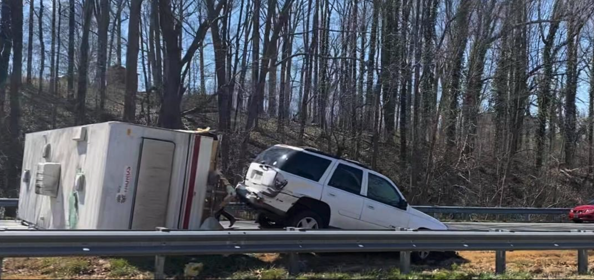 A wrecked RV and Chevy Trailblazer blocking I-40