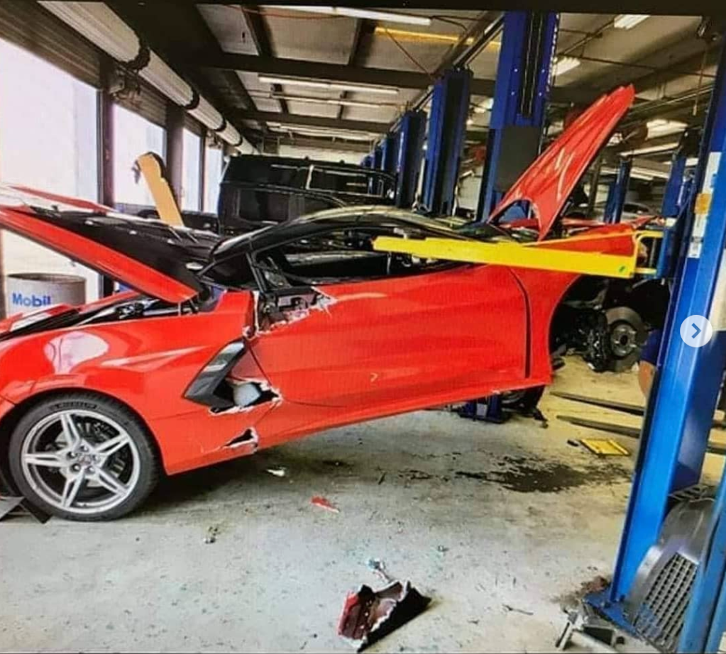 An image of a red Chevrolet Corvette that fell off of a lift in Florida.