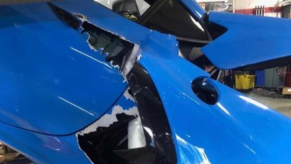 An image of a 2021 Chevrolet Corvette that fell from a mechanic's lift.
