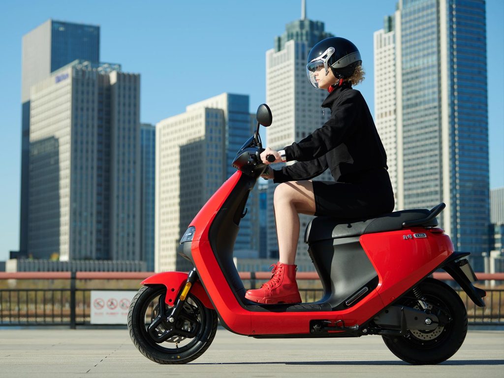 woman riding red Segway e-scooter