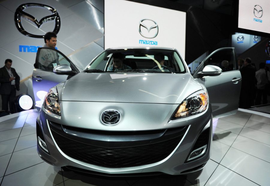 A silver Mazda3 on display at an auto show