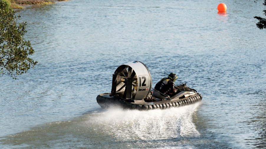 Simon Larman races his silver-and-black hovercraft through the Gang Warily river circuit