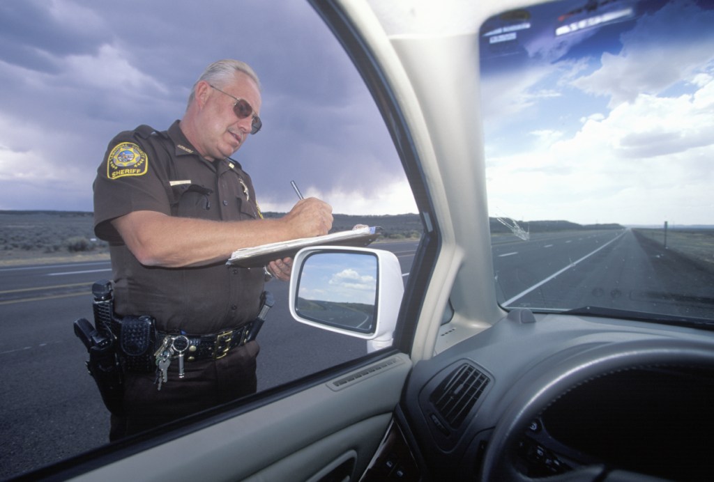 A police officer writing a speeding ticket