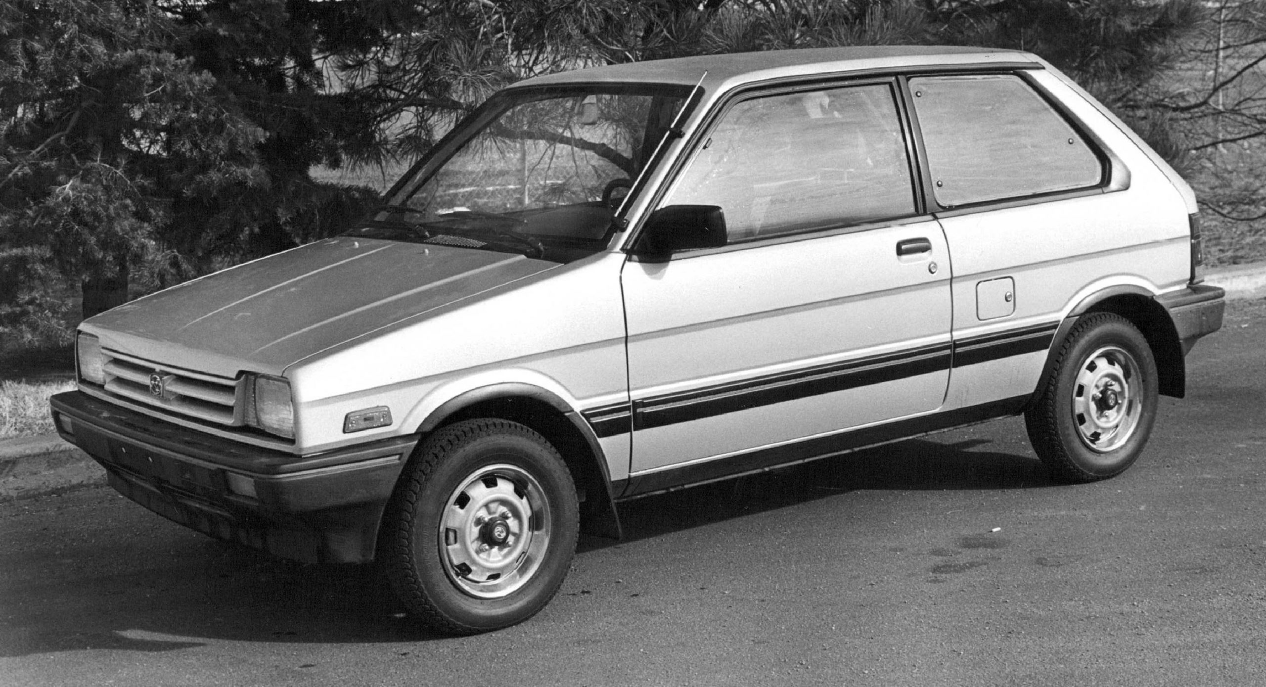 A black and white image of a late 1980s Subaru Justy hatchback