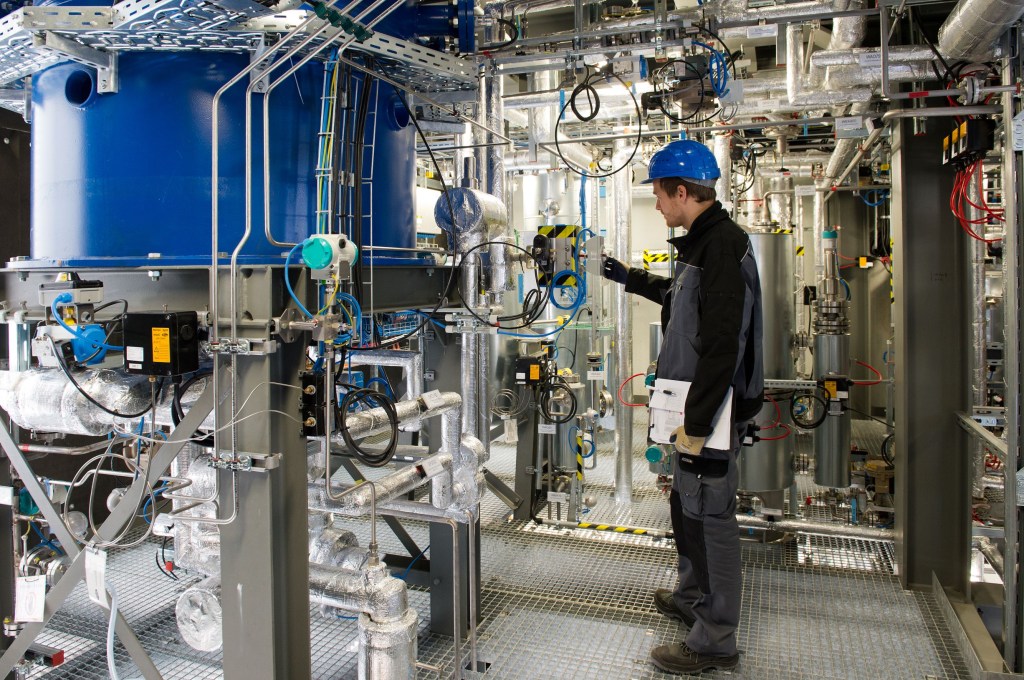 A work checks equipment in Sunfire's Dresden, Germany synthetic fuel pilot plant