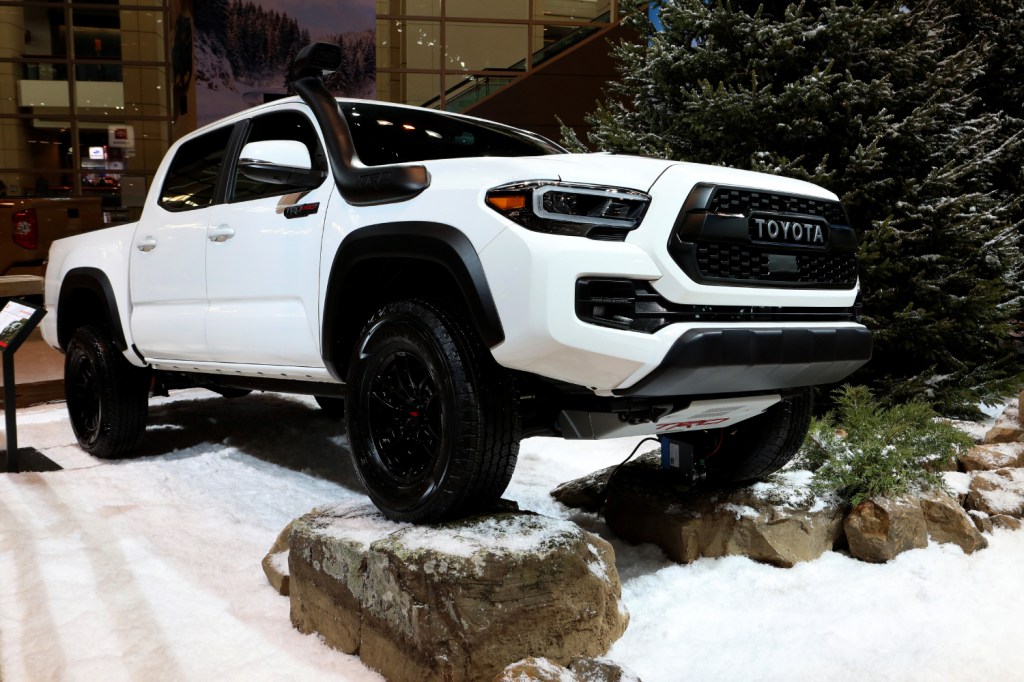 A white 2020 Toyota Tacoma TRD Pro on display at an auto show