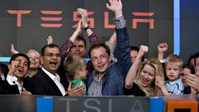Elon Musk and some Tesla employees ring the bell at the stock exchange