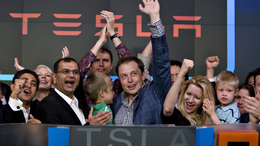 Elon Musk and some Tesla employees ring the bell at the stock exchange