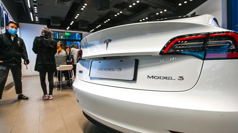 A Tesla Model 3 sits on display in a dealership