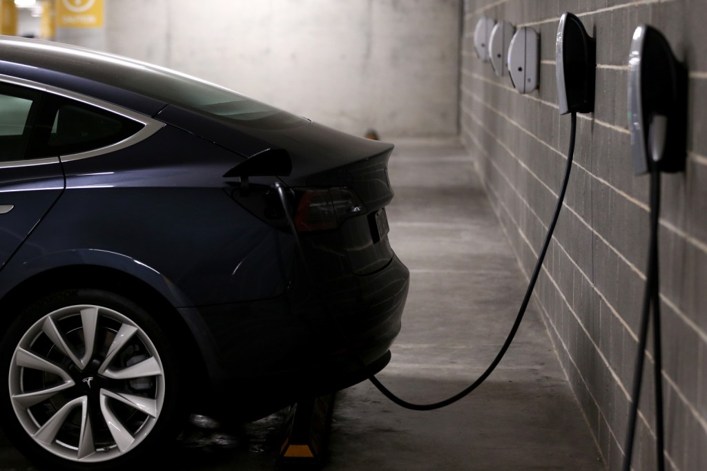 A Tesla Model Y plugged in and charging at home