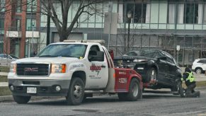 Tow truck towing a beat up Land Rover