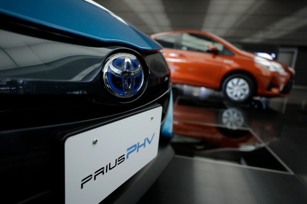 A Toyota Motor Corp. badge is displayed on a Prius plug-in hybrid vehicle (PHV), known as Prius Prime in the U.S., at the company's head office in Tokyo