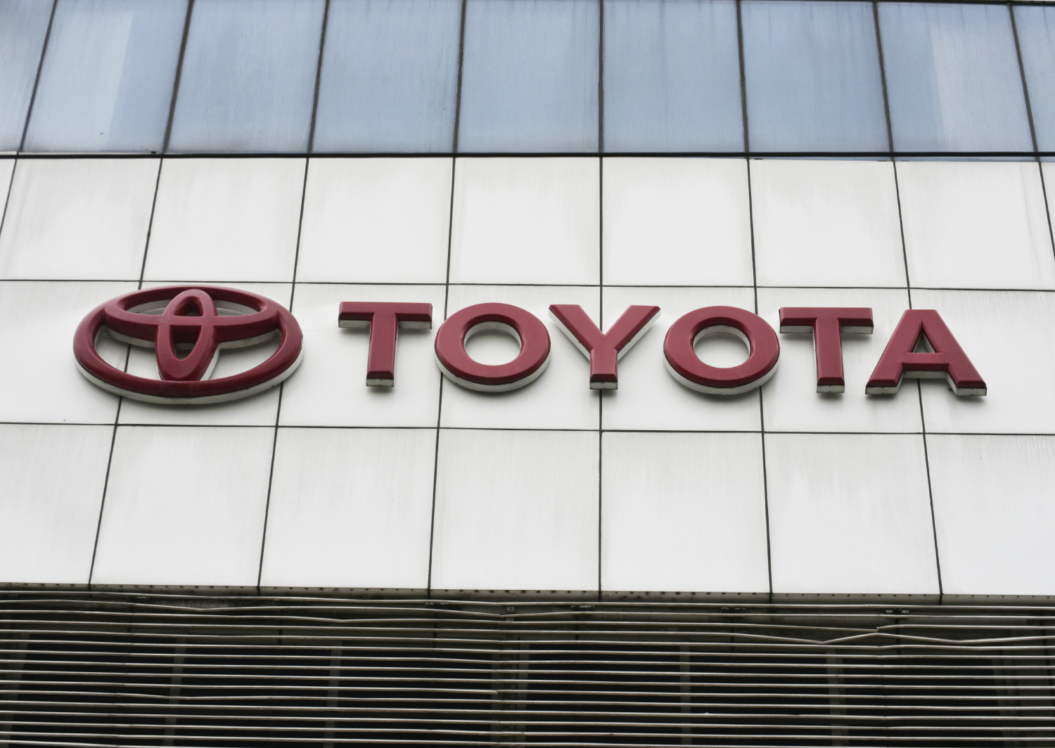 A Toyota sign on the building of a showroom
