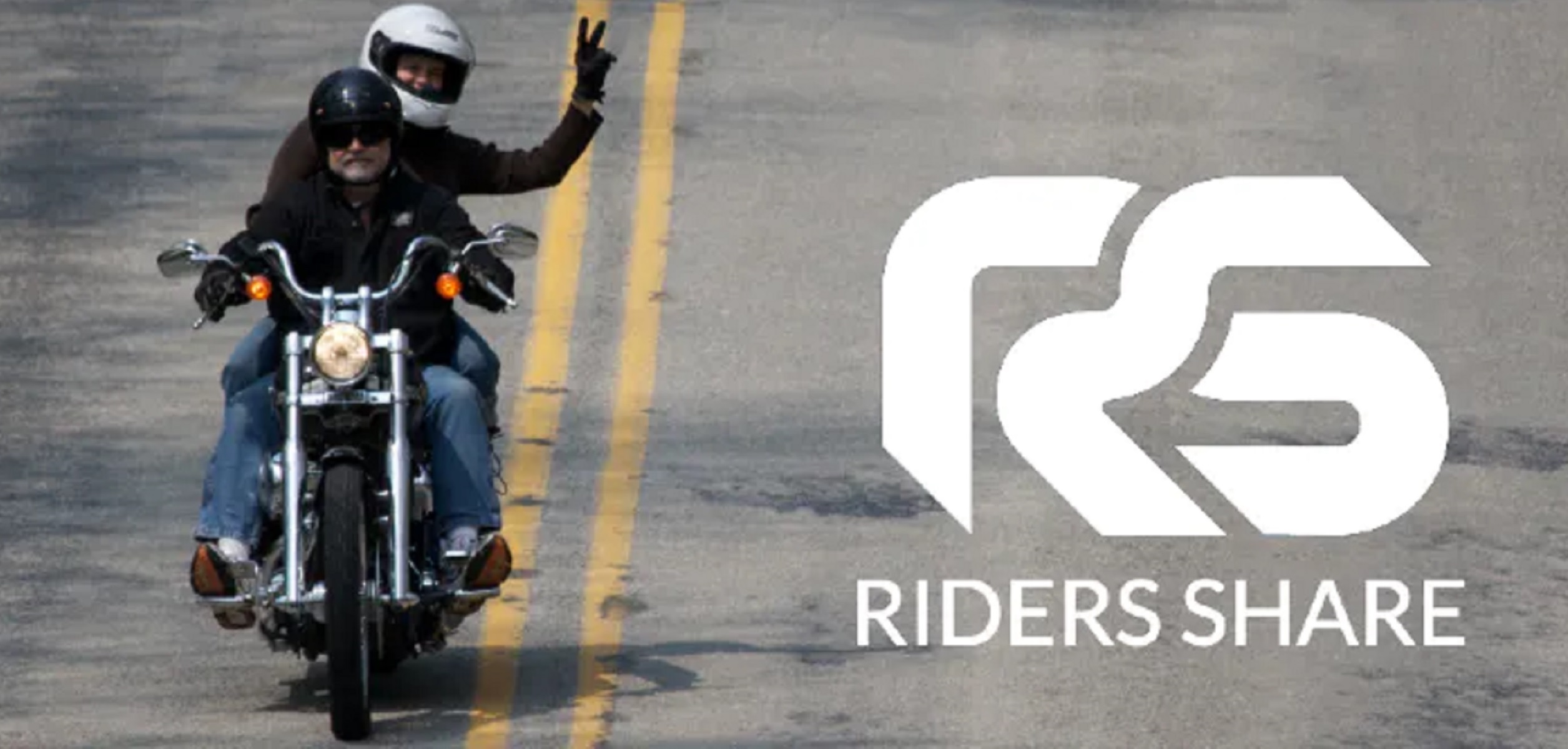 Two riders ride a rented cruiser down the road