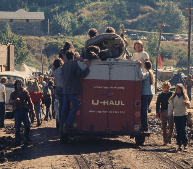 U-Haul trailer with hippies around it